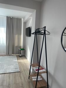 a room with a shelf and a television on a wall at Bon Mary Hotel in Astana