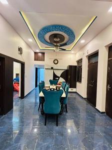 a room with a table and chairs and a ceiling at Ajmer villa -3 km from bus stand in Ajmer