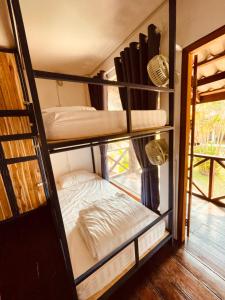 a room with two bunk beds in a room at The Jam Hostel Luang Prabang in Luang Prabang
