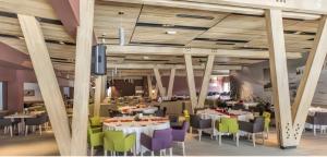 a dining room with tables and chairs and a tv at Apartments B229 & B230 in Aparthotel Vucko, Jahorina -private host in Jahorina