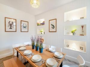 a dining room with a wooden table and chairs at Townhouse in Llandudno