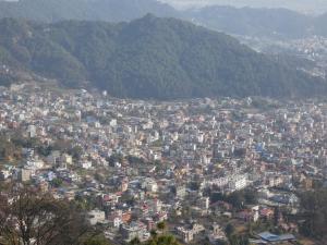 a view of a city with mountains in the background at Sara's Backpackers Hotel in Kathmandu