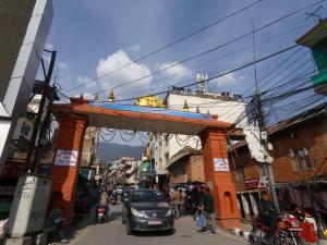 a street with a gate in the middle of a city at Sara's Backpackers Hotel in Kathmandu