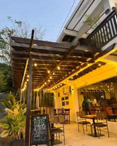 a patio with tables and chairs under a pergola at Canto Tièro Cabin 1 in Batangas City