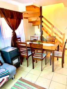 a dining room with a wooden table and chairs at Casa mirador lago in Panguipulli +11 photos