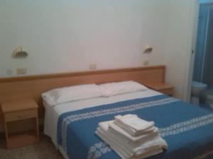 Postel nebo postele na pokoji v ubytování K2 Hotel