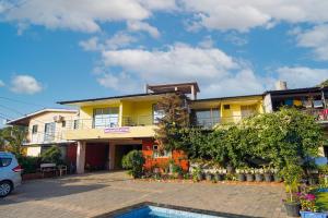 a yellow house with a pool in front of it at Berry Fresh Stays Mahabaleshwar With Pool in Mahabaleshwar