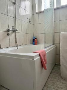 a bathroom with a bath tub with a towel on it at City Apartment Gevgelija in Gevgelija