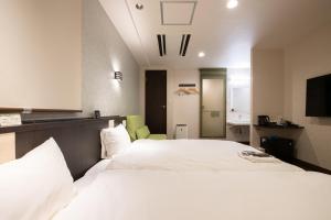 Postel nebo postele na pokoji v ubytování Ueno First City Hotel + 37 fotografií