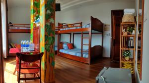 a room with two bunk beds and a table at Việt Homestay Quy Nhơn in Quy Nhon