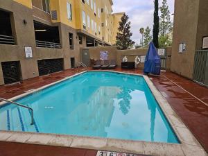 a large swimming pool in front of a building at Five minutes walk unit Disneyland Anaheim Staybridge Suites in Anaheim