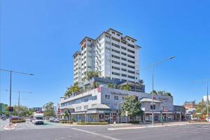 a tall white building on the corner of a street at Inner City Gem - Stunning Views in Cairns