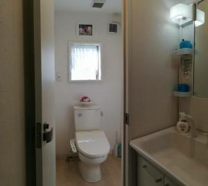 a bathroom with a toilet and a sink and a window at Hanmadang in Osaka