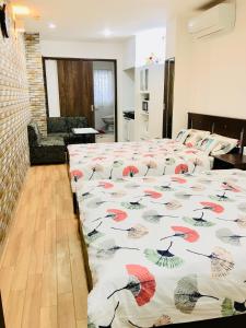 a bedroom with two beds with a comforter at Hanmadang in Osaka