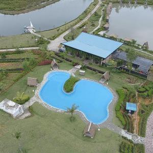 an overhead view of a swimming pool next to a building at "D'BAMBOO KAMP" Desa Wisata Ekang in Lagoi