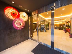 a lobby with two umbrellas on the wall at Hotel IL Verde Kyoto in Kyoto
