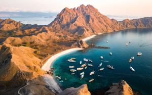 an aerial view of a beach with boats in the water at DAILY TRIP KOMODO TOUR in Labuan Bajo