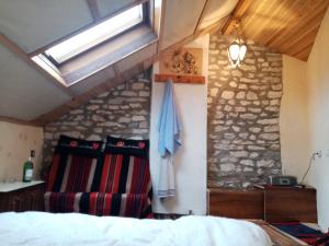 a bedroom with a bed and a stone wall at Residence "Ana Pletvarska" in Prilep