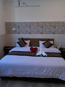 łóżko z dwoma pluszakami siedzącymi na nim w obiekcie SR Hotel & Restaurant 2.0 w mieście Lohārakot
