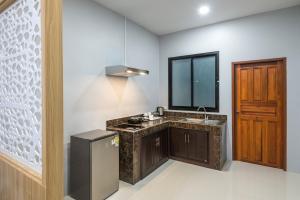 a kitchen with a sink and a mirror at Mook Anda Villa in Ao Nang Beach