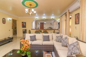 a living room with a white couch and a table at Dubai infinite luxury suites in Malindi