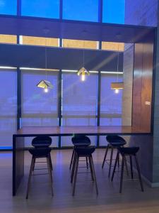 a table and chairs in a room with lights at USJ One Residence Cozy Homestay Subang Jaya Sunway in Subang Jaya +37 photos