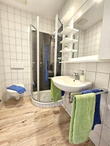 a bathroom with a sink and a shower and a toilet at Buten un Binnen in Norderney