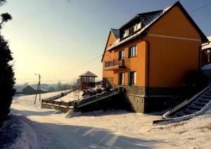 a house in the snow with a gazebo at Moja Ostoja in Kluszkowce