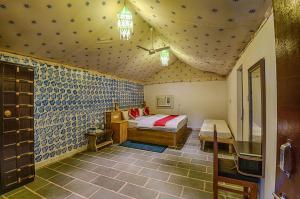 a bedroom with a bed in a room with blue tiles at Club Desert Safari Jaisalmer in Sām