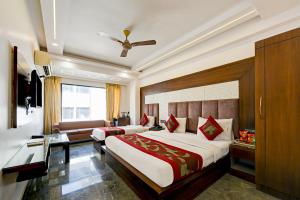 a bedroom with a large bed and a couch at Hotel Sohana Palace Near New Delhi Railway Satation in New Delhi
