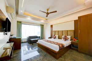 a hotel room with a bed and a television at Hotel Sohana Palace Near New Delhi Railway Satation in New Delhi