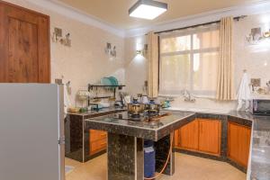 a kitchen with a sink and a counter top at Dubai infinite luxury suites in Malindi