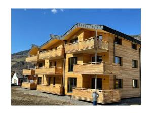 a large building with wooden balconies and a parking meter at Holiday apartment Alpenblick in Sankt Lorenzen ob Murau