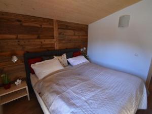 a bedroom with a large bed with wooden walls at Holiday apartment Alpenblick in Sankt Lorenzen ob Murau