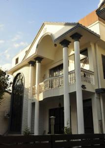 Casa blanca con porche y balcón en MicasaNepal en Katmandú