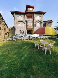 a table and chairs in front of a house at Hotel Bakhtawar in Srinagar