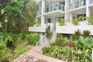 an apartment building with a staircase and plants at Tropical Luxe Apartment in Townsville