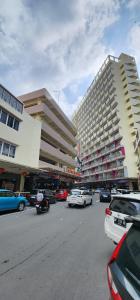 a parking lot with cars parked in front of a building at Nagoya Thamrin City Apartment High Floor in Nagoya