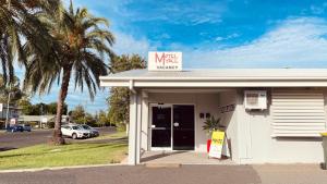 a white building with a sign on top of it at Motel Myall in Dalby +54 photos