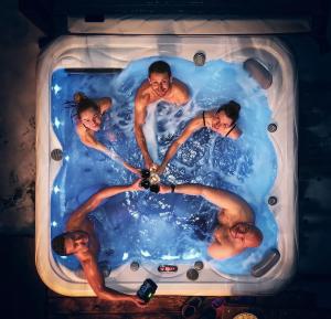a group of people in a bath tub at Sky-House Jasná Apartments in Pavčina Lehota +55 photos