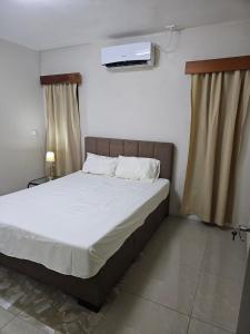 a bedroom with a bed with a tv on the wall at Bula Stay in Nadi