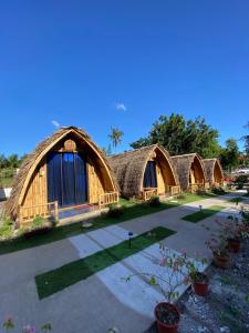 a row of houses with thatched roofs at East Holiday Resort Moalboal in Moalboal