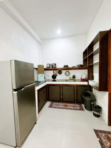 a kitchen with a stainless steel refrigerator at Casa De Loren Family Room in General Luna