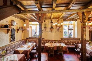 a restaurant with tables and chairs in a room at Hotel Doctor Weinstube in Bernkastel-Kues