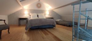 a bedroom with a bed and a ladder in a room at La Petite Maison in Givry +46 photos