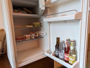 an open refrigerator filled with lots of bottles of alcohol at naturnah am Donauradweg in Riedlingen