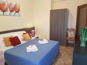 a bedroom with a blue bed with towels on it at B&B Monté in Montesilvano