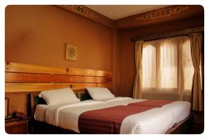Postel nebo postele na pokoji v ubytování Hotel Jigmeling