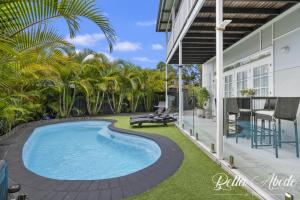 a swimming pool on the side of a house at Bella Abode on Bribie - Loft with Pool in Bongaree