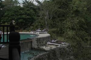 una piscina con sedie a sdraio accanto al resort di Siddhartha Vilasa Banbas, Chitwan a Chitwan